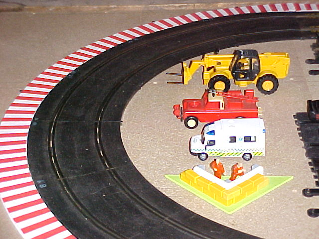 Corner with white and red borders and vehicles