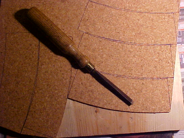Sheet of cork and chisel on wooden block
