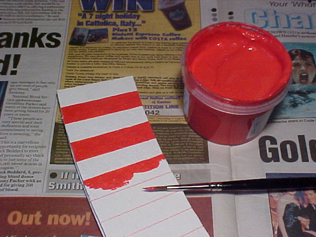 White cork border, red paint and brush
