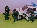 2 ambulance crews in green jumpsuits