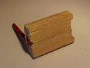 Wooden block, pencil and rubber bands